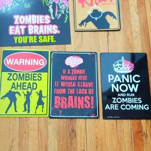 Six metal zombie signs.